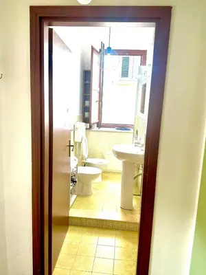 a bathroom with a toilet and a sink at Via del Bosco Home in Palermo
