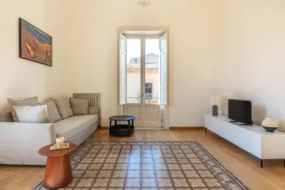 a living room with a couch and a tv at Carlo Apartment with Terrace by Wonderful Italy in Palermo