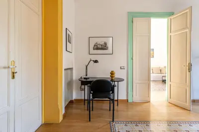 a hallway with a table and a chair in a room at Carlo Apartment with Terrace by Wonderful Italy in Palermo