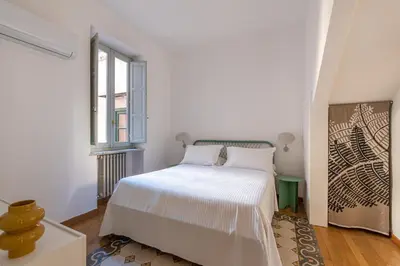 a white bedroom with a bed and a window at Carlo Apartment with Terrace by Wonderful Italy in Palermo