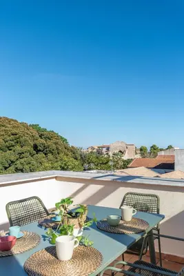 a patio with two tables and chairs on a roof at Carlo Apartment with Terrace by Wonderful Italy in Palermo