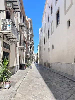 an empty street in a city with buildings at Dimora dell'Olivella 1 in Palermo