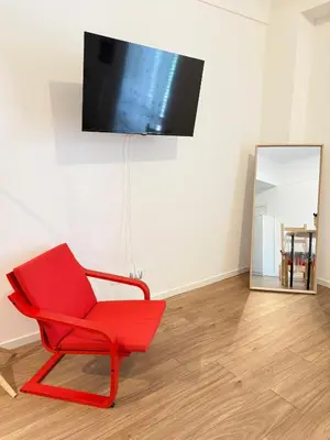 a red chair in a room with a mirror at Dimora dell'Olivella 1 in Palermo