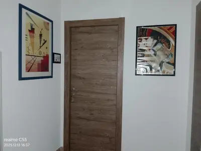 two pictures hanging on a wall next to a door at Casa Claudia in Palermo