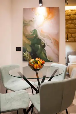 a dining room with a glass table and chairs at Lo Storico Apartment in Palermo