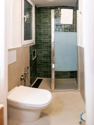 a bathroom with a toilet and a shower at Lo Storico Apartment in Palermo