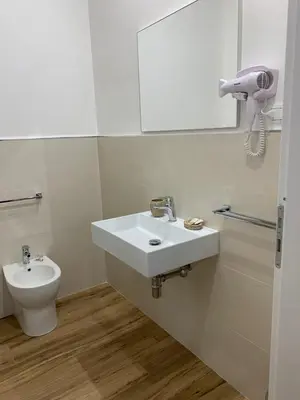 a bathroom with a sink and a toilet at Titti's Room in Casteldaccia