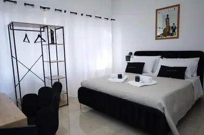 a bedroom with a bed with two cups on it at Tolo Tolo Apartaments in Palermo