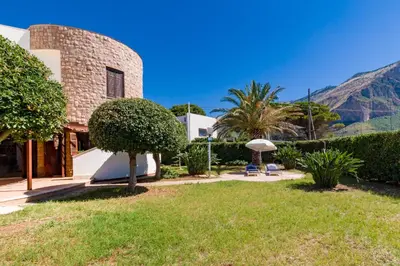 a kitchen with a table and chairs in a room at LeSicilien - Tilde Sunset Bay Villa in Carini
