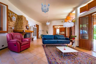 a living room with two blue couches and a table at LeSicilien - Tilde Sunset Bay Villa in Carini