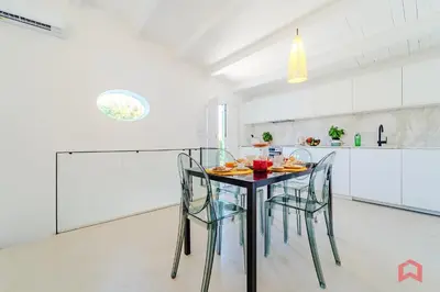 a dining room with a table and chairs in a kitchen at Incantevole Appartamento nel cuore di Palermo in Palermo