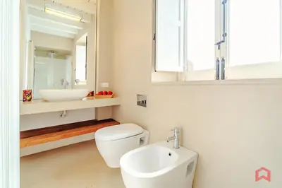 a bathroom with a sink and a toilet and a mirror at Incantevole Appartamento nel cuore di Palermo in Palermo
