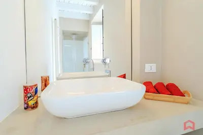 a bathroom with a white sink and a mirror at Incantevole Appartamento nel cuore di Palermo in Palermo