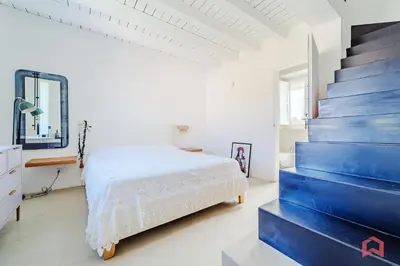a bedroom with a bed and a blue staircase at Incantevole Appartamento nel cuore di Palermo in Palermo