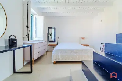 a white bedroom with a bed and a mirror at Incantevole Appartamento nel cuore di Palermo in Palermo