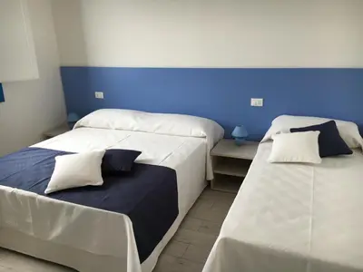 two beds sitting next to each other in a room at Le case di Palma in San Vito lo Capo