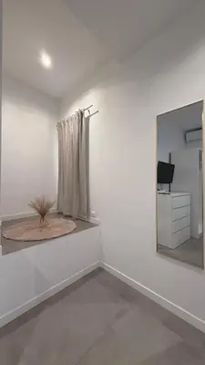 a white bedroom with a bed and a dresser at CR Home in Palermo