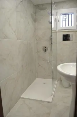 a bathroom with a shower and a sink at VitaNova Apartment in Palermo