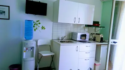 a small kitchen with white cabinets and a sink at B&b Bagheria in Bagheria