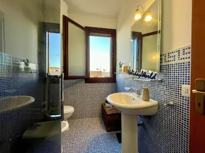 a bathroom with a sink and a toilet and a mirror at Casa Sterlizia by Holiday World in San Vito lo Capo