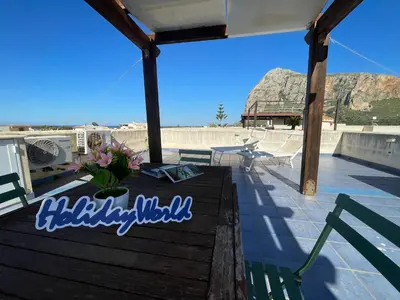 a table on a roof with a view of the beach at Casa Sterlizia by Holiday World in San Vito lo Capo