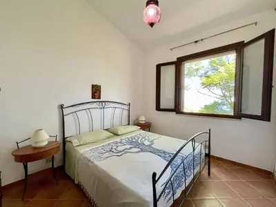 a bedroom with a bed and a window at Villa Dorotea in Castellammare del Golfo