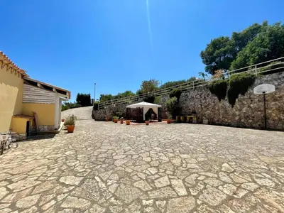 a tent is set up on a stone patio at Villa Dorotea in Castellammare del Golfo