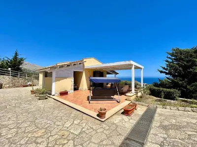 a house with a deck with a view of the ocean at Villa Dorotea in Castellammare del Golfo