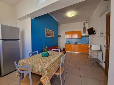 a kitchen and dining room with a table and chairs at Case d'estate Mondello in Palermo
