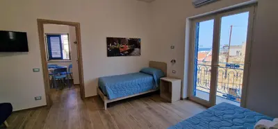 a room with a bed and a balcony with a view at Casa Elisa in Palermo
