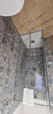 a bathroom with a shower with a glass wall at Casa Elisa in Palermo