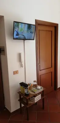 a room with a table with a tv on the wall at Marku's House in Palermo