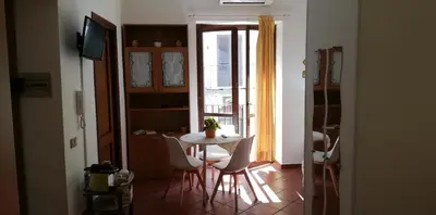 a table and chairs in a room with a window at Marku's House in Palermo