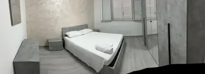 a bedroom with a bed with white sheets and pillows at BALISTRERI HOUSe in Trabia