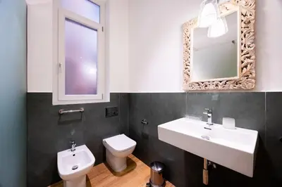 a bathroom with a sink and a toilet and a mirror at Rosalia e le altre in Palermo
