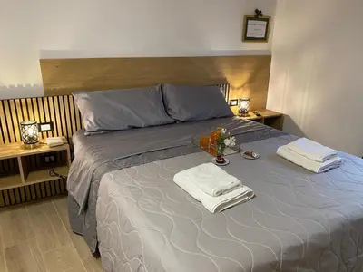 a bedroom with a bed with two towels on it at Onyx Home in Palermo
