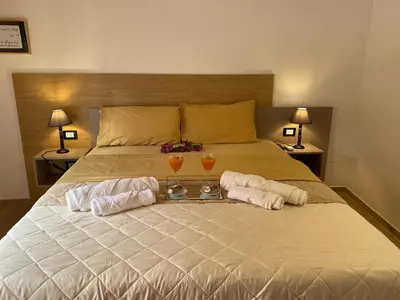 a bedroom with a bed with two glasses on it at Onyx Home in Palermo