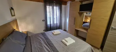 a bedroom with a bed with two towels on it at Onyx Home in Palermo