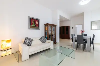 a living room with a couch and a table at GuestHost - Palermo Roomy and Modern Apartment in Palermo