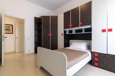 a bedroom with a bed and some cabinets at GuestHost - Palermo Roomy and Modern Apartment in Palermo