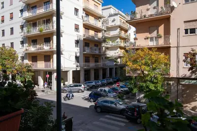 an apartment building with cars parked in a parking lot at GuestHost - Palermo Roomy and Modern Apartment in Palermo