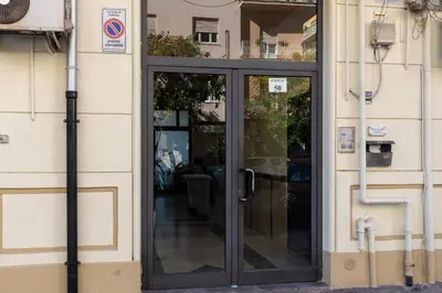 a glass door of a building with at GuestHost - Palermo Roomy and Modern Apartment in Palermo