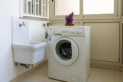 a washing machine in a bathroom with a toilet at GuestHost - Palermo Roomy and Modern Apartment in Palermo