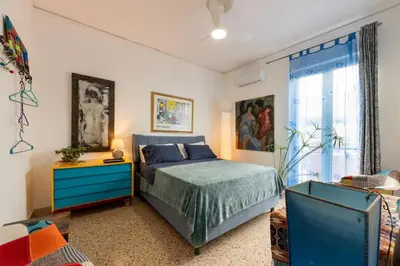 a bedroom with a bed and a blue dresser at Terrace in the Sky overlooking Historic Center in Palermo