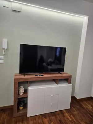 a flat screen tv sitting on top of a white entertainment center at Court Holiday - La casa del Giudice in Palermo