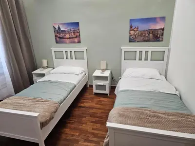 a bedroom with two beds and two night stands at Court Holiday - La casa del Giudice in Palermo