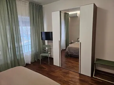 a bedroom with a mirror and a bed and a desk at Court Holiday - La casa del Giudice in Palermo
