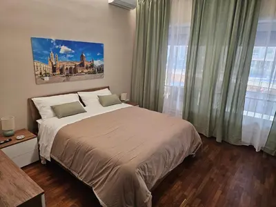 a bedroom with a large bed and a large window at Court Holiday - La casa del Giudice in Palermo