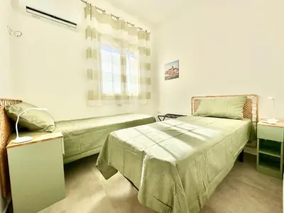 a hospital room with two beds and a window at Zàgave Apartment a 200 mt dal mare in Alcamo