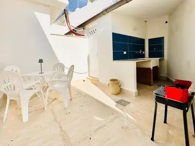 a dining room with a table and a piano at Zàgave Apartment a 200 mt dal mare in Alcamo